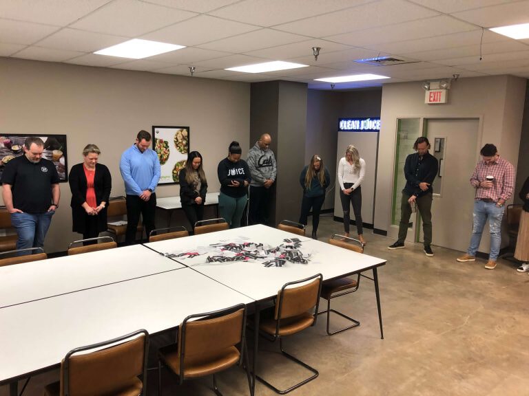 Team-standing-and-bowing-their-heads